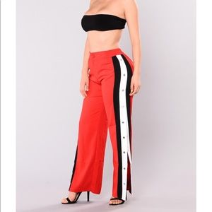 Red snap pants with black and white striped sides